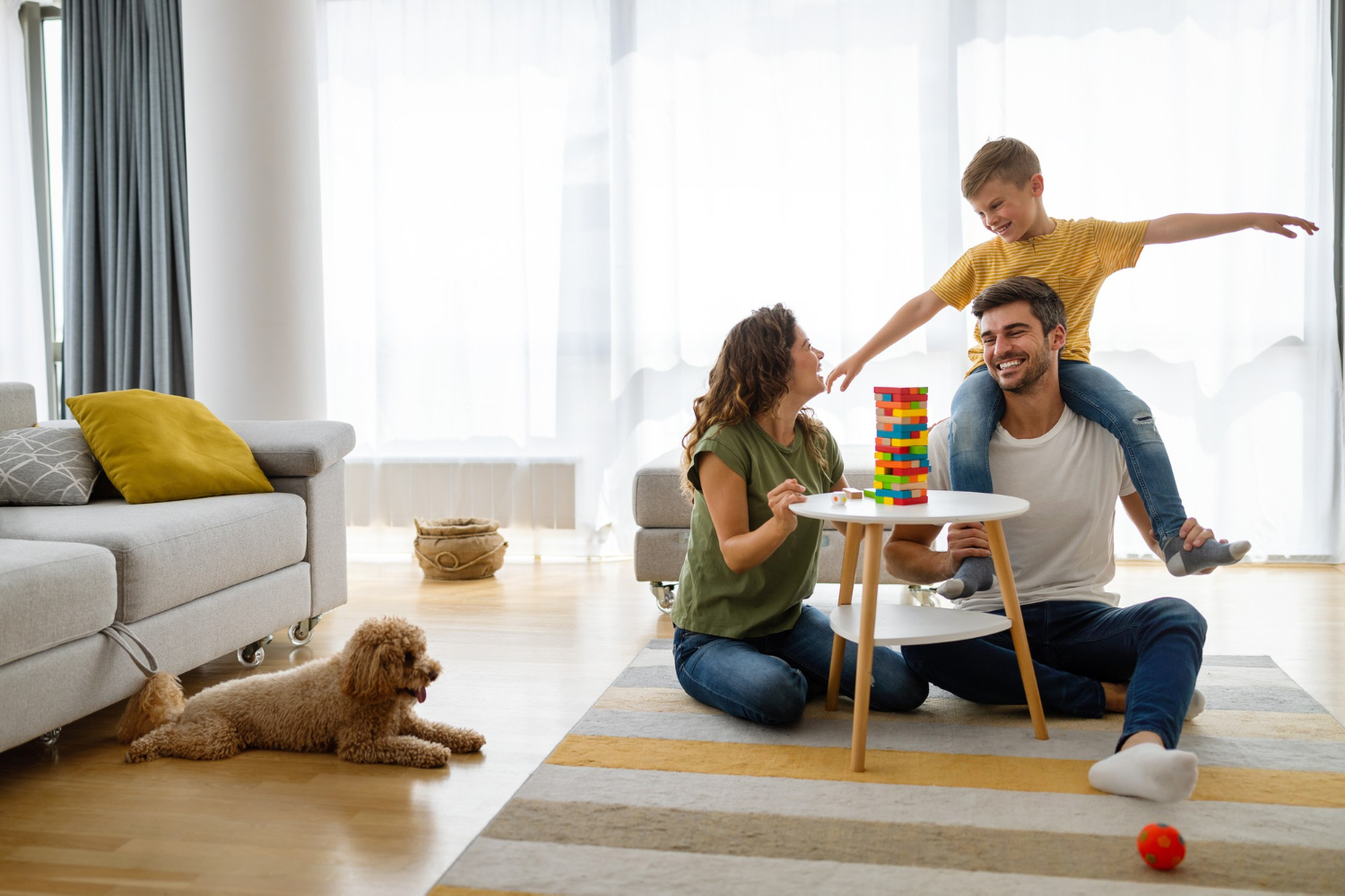 happy-young-family-having-fun-time-playing-together-home-with-dog